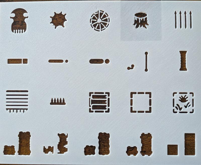 Hands using stencils to create Tabletop RPG battle maps on a grid