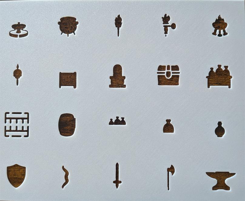 Close-up of a hand using a furniture stencil to trace beds, tables, and chairs onto a battle map grid